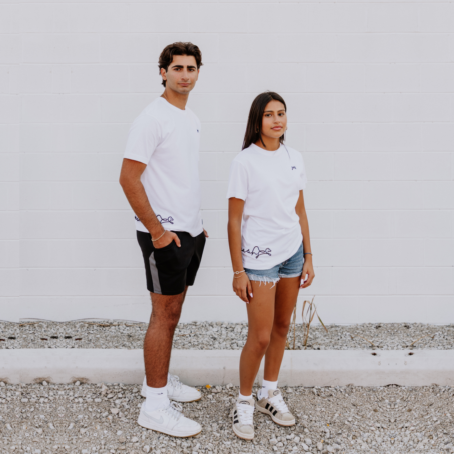 Models wearing OOsmash women’s white T-Shirt featuring clean stitching and flattering fit.