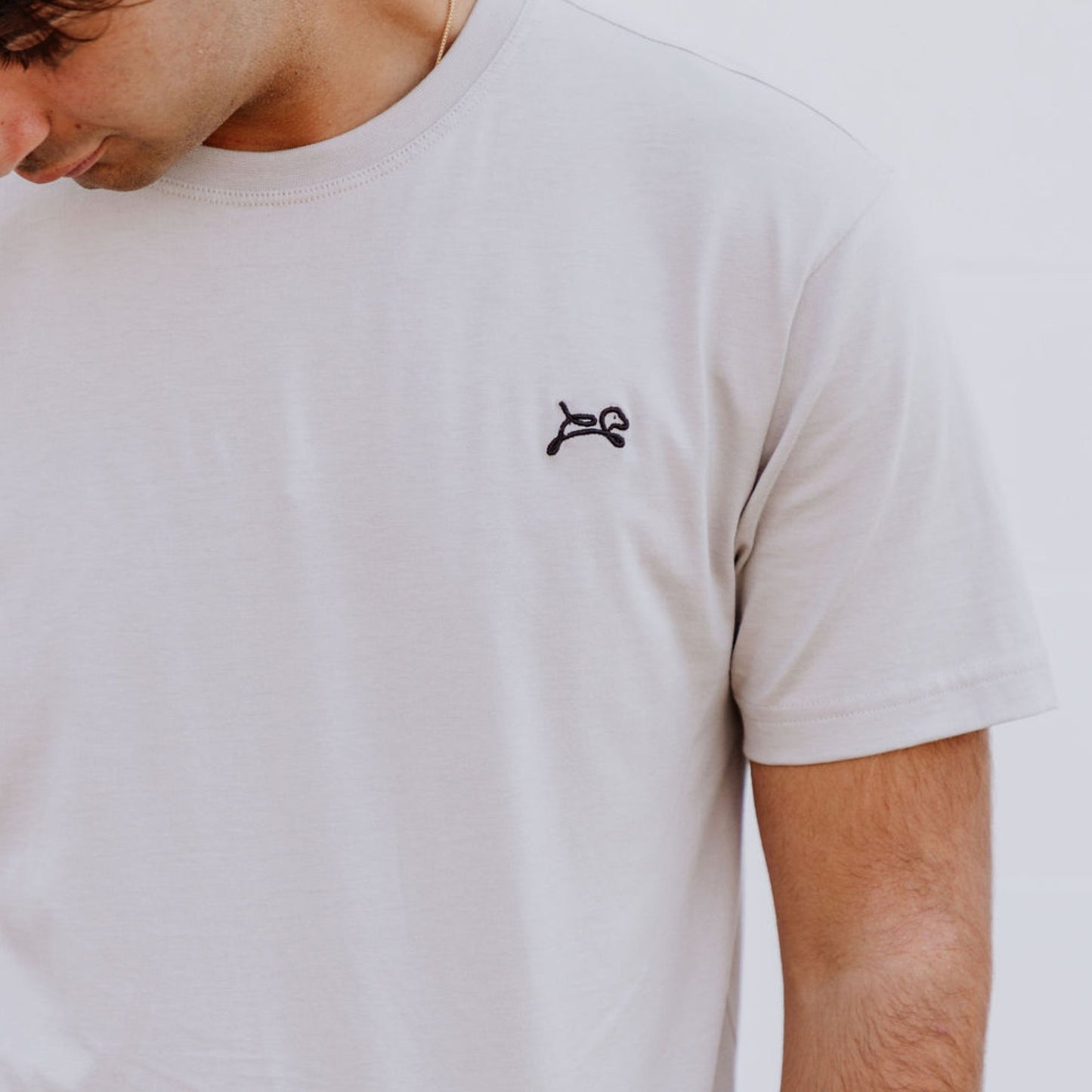 Model wearing OOsmash men’s beige T-Shirt featuring clean seams and relaxed fit.