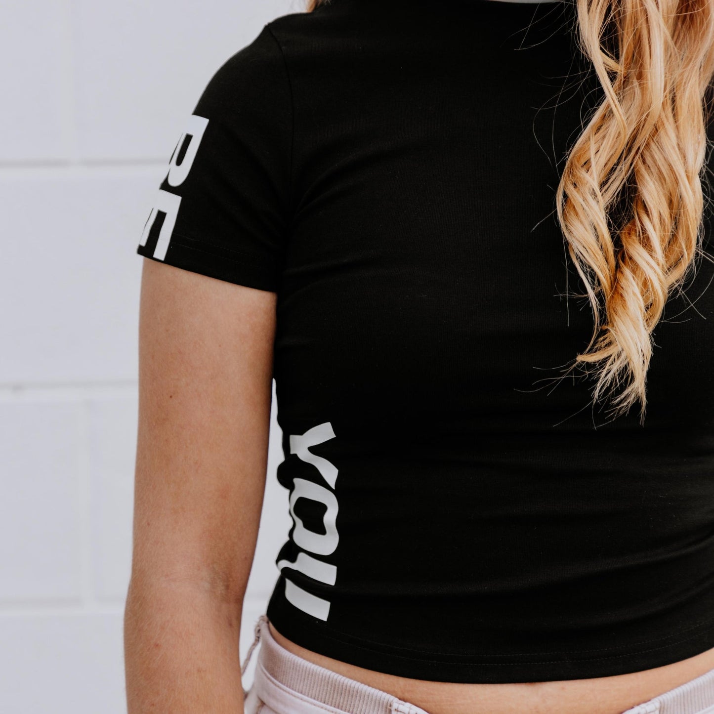 OOsmash black crop tee made from 92% cotton and 8% spandex with soft, flexible fit.