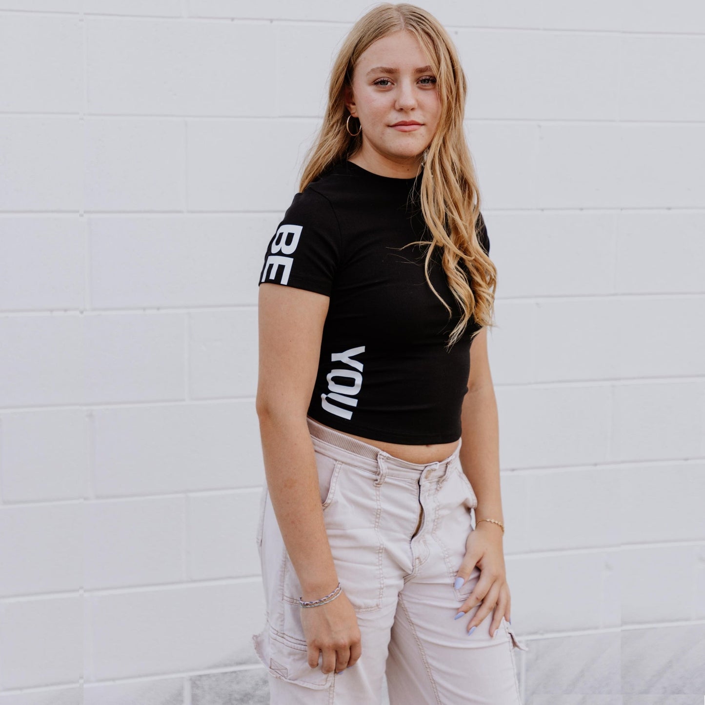 OOsmash black crop tee made from 92% cotton and 8% spandex with soft, flexible fit.