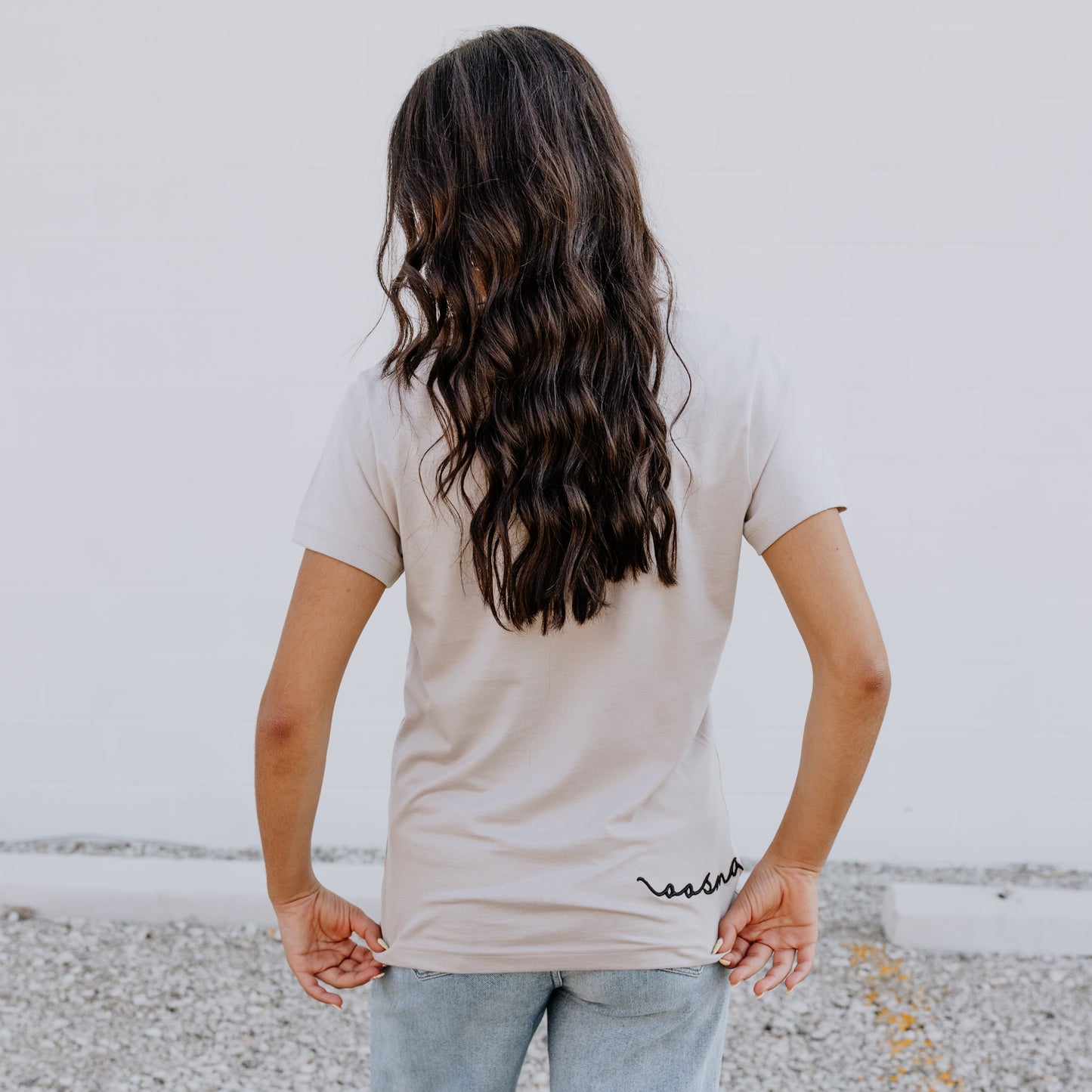 Model wearing OOsmash women’s beige T-Shirt featuring smooth fabric and flattering tailored fit.