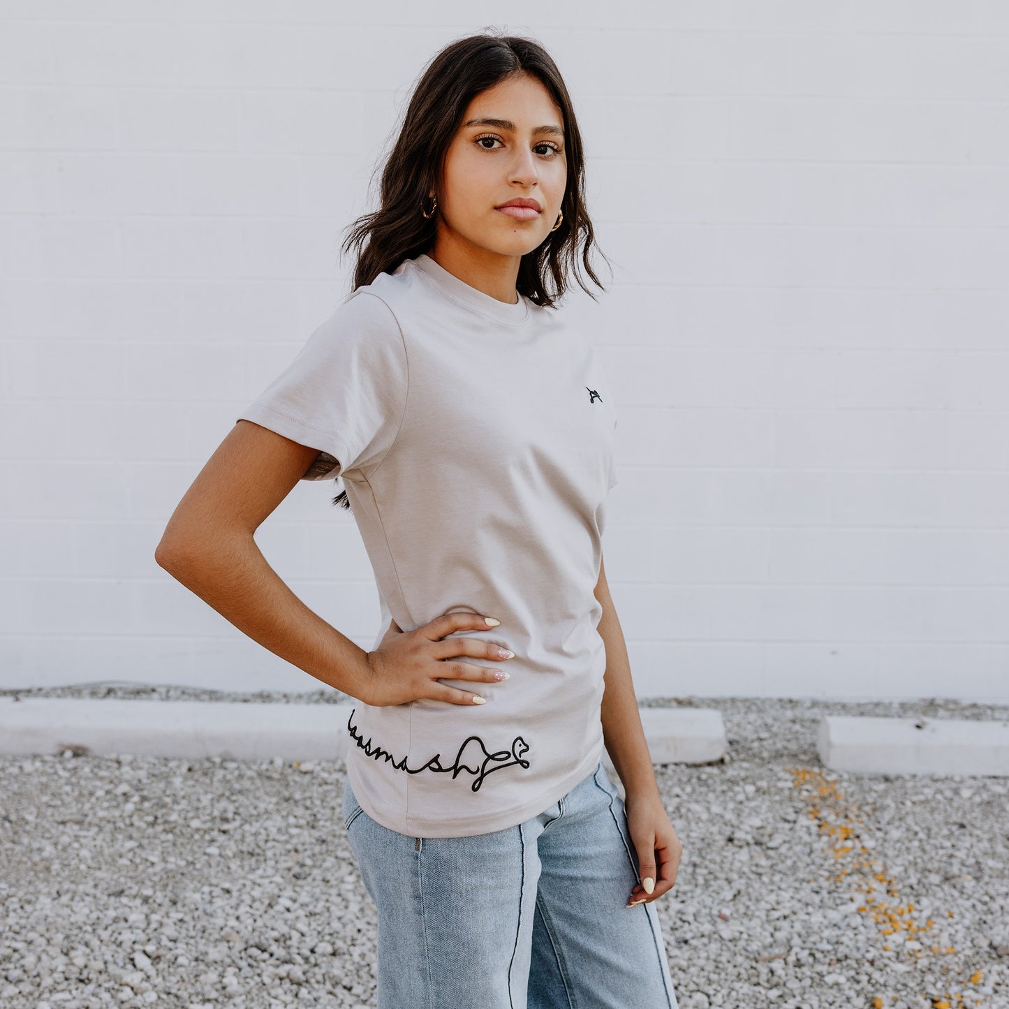 Model wearing OOsmash women’s beige T-Shirt featuring smooth fabric and flattering tailored fit.