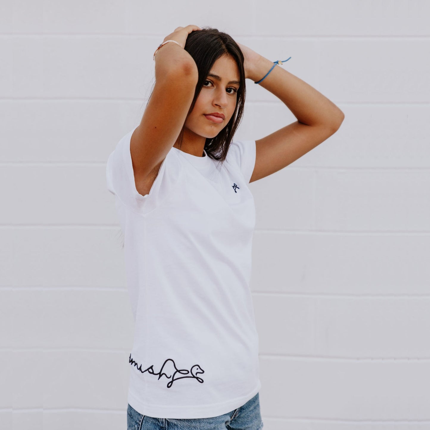 Model wearing OOsmash women’s white T-Shirt featuring clean stitching and flattering fit.