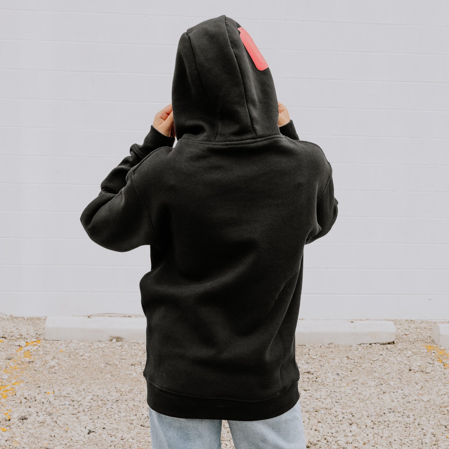 Black Women's OOsmash Plug Hoodie back view with bold red European plug design - statement style