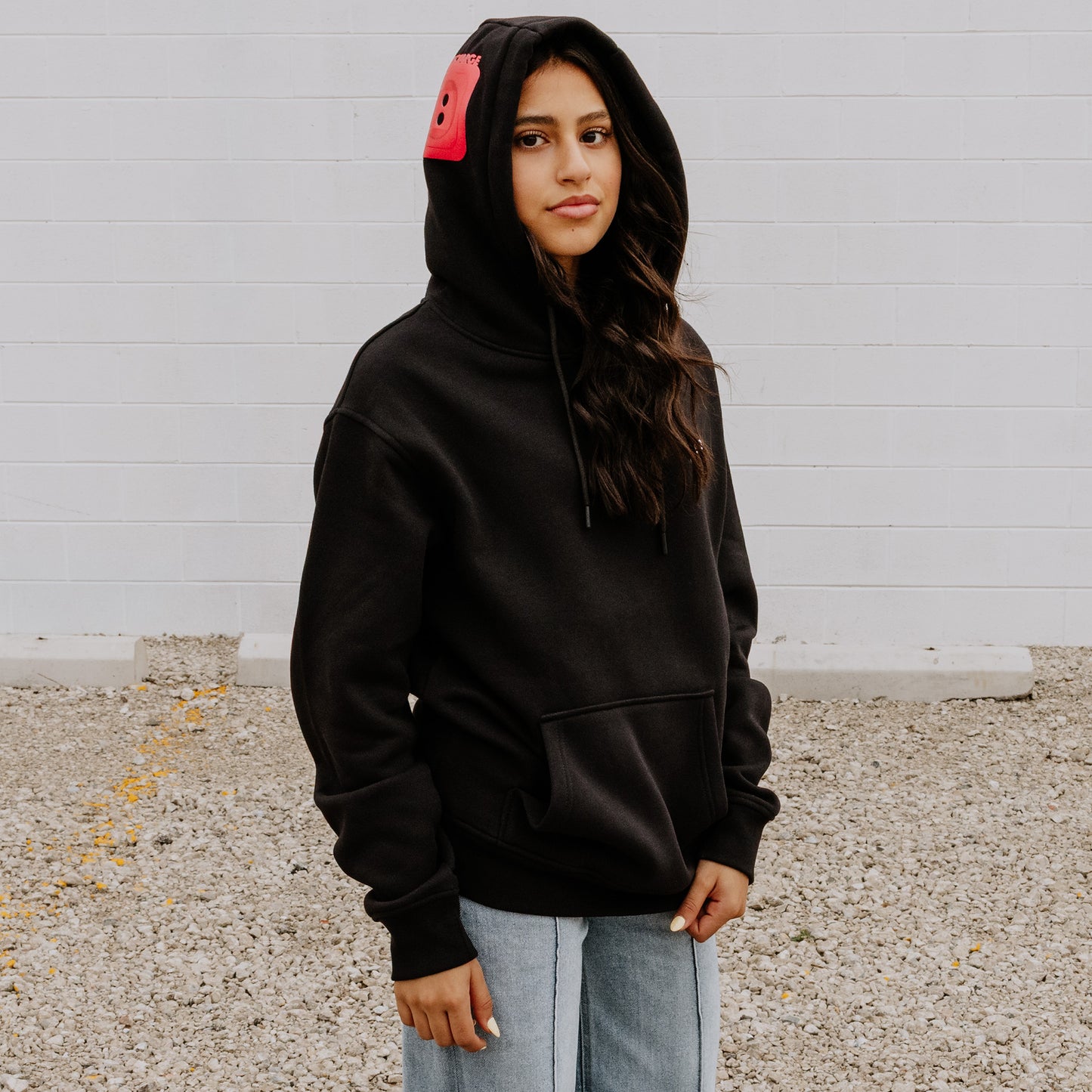 Women's Black OOsmash Plug Hoodie with red European plug design on hood - bold confidence, premium style