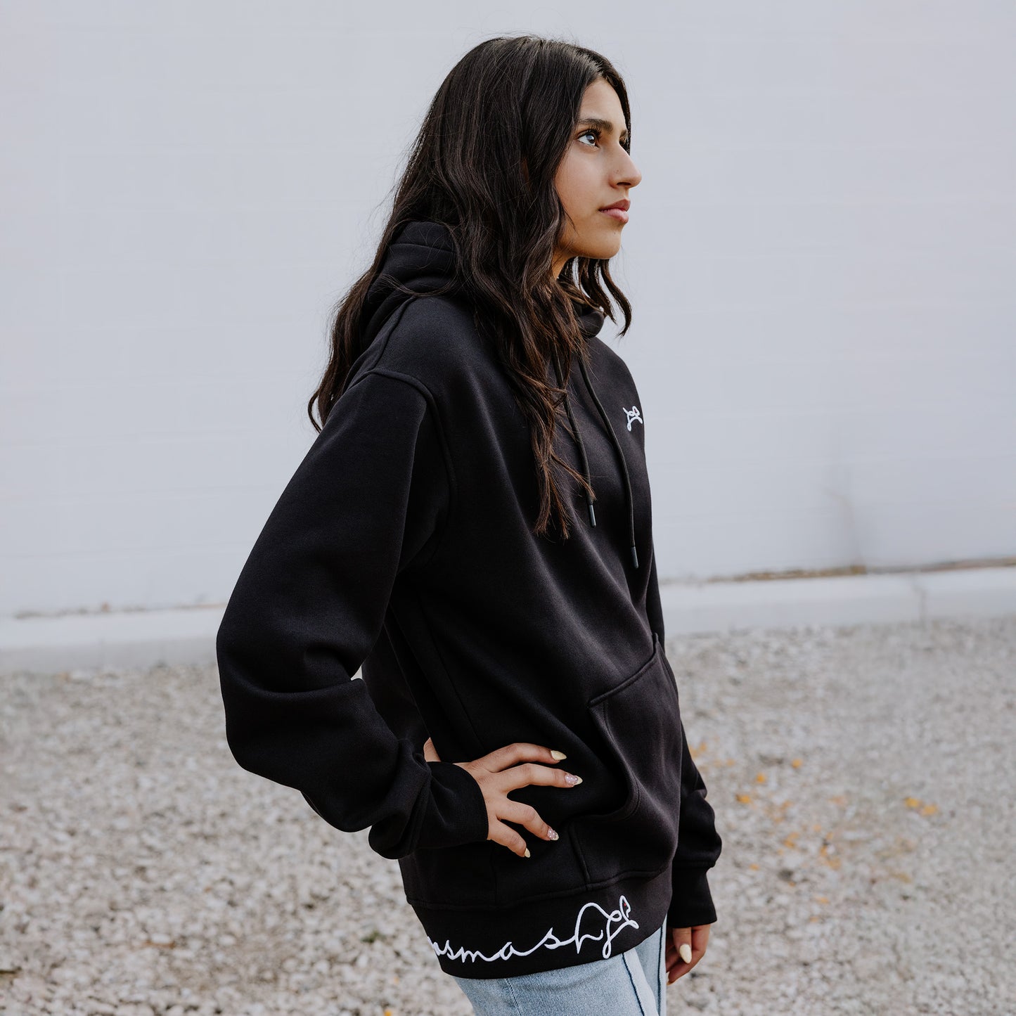 Female Model wearing OOsmash women’s Signature hoodie in black with soft, premium fabric.