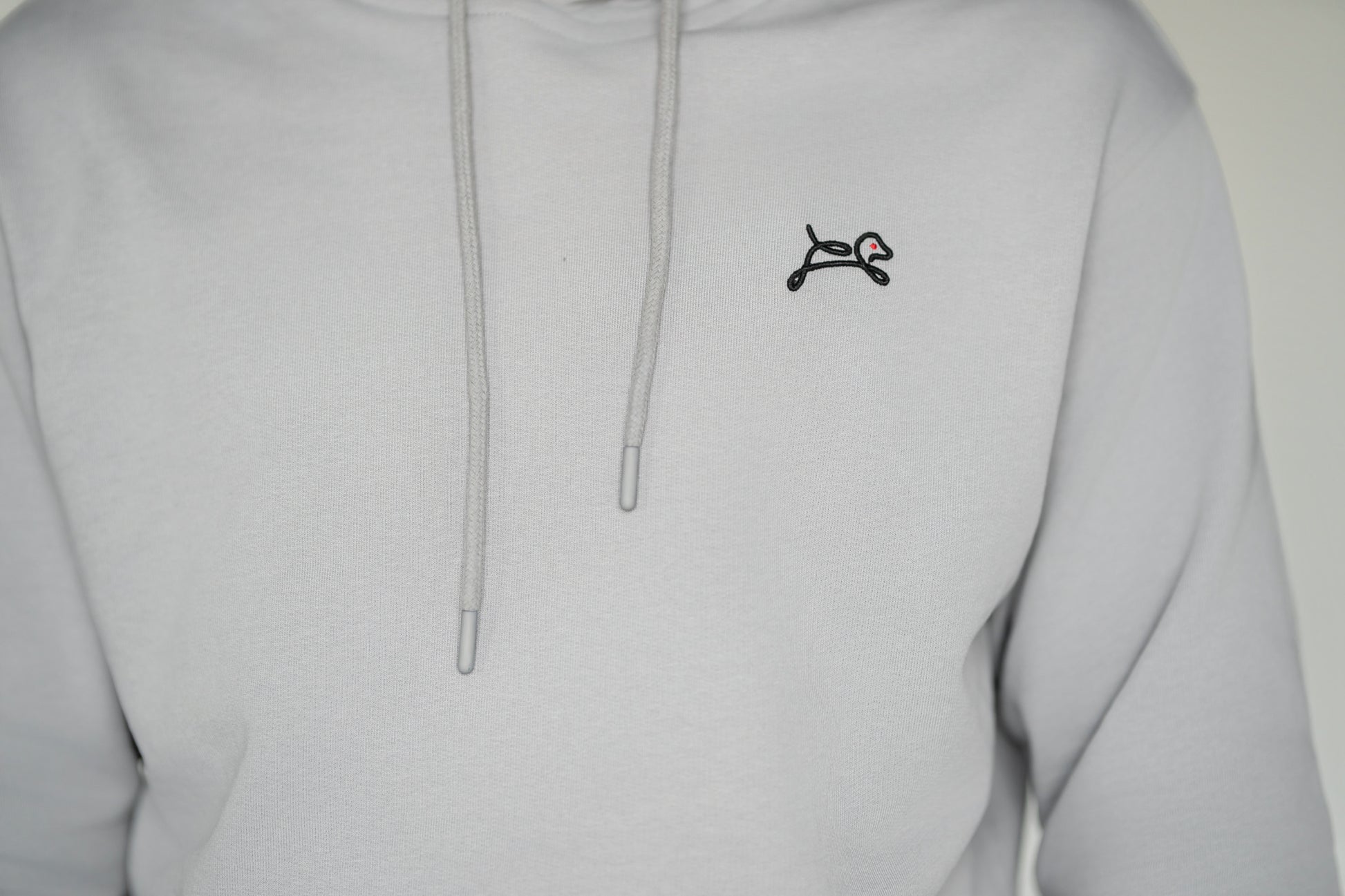 OOsmash Speak Up Hoodie — close-up of OOsmash signature embroidered logo, premium French Terry Cotton 