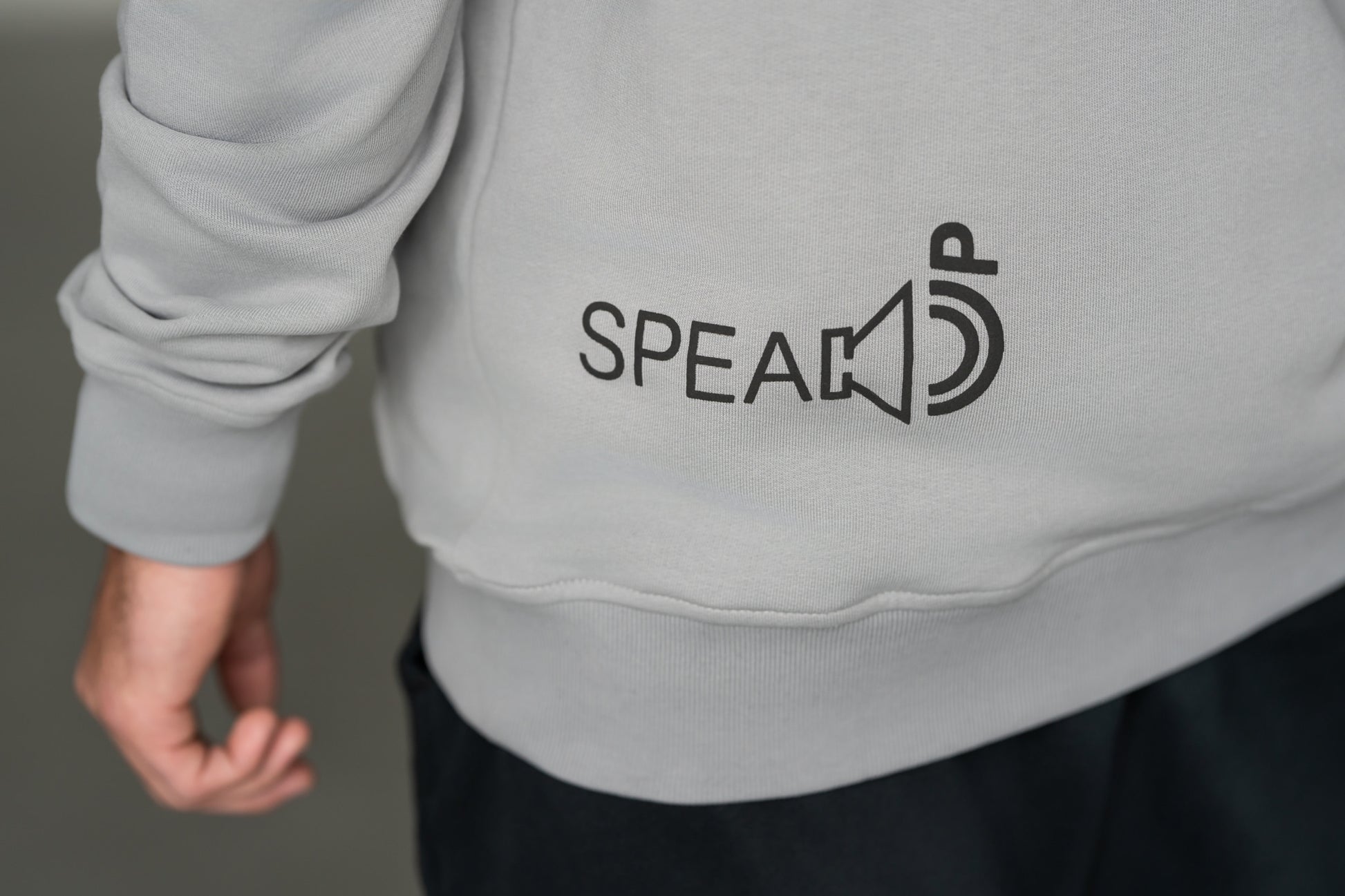 OOsmash Speak Up Hoodie — close-up of bold Speak Up graphic print, statement back design, light gray French Terry Cotton