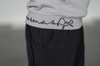 OOsmash Signature Hoodie — close-up signature embroidery detail on hem, artisan stitch luxury men's hoodie, OOsmash craftsmanship