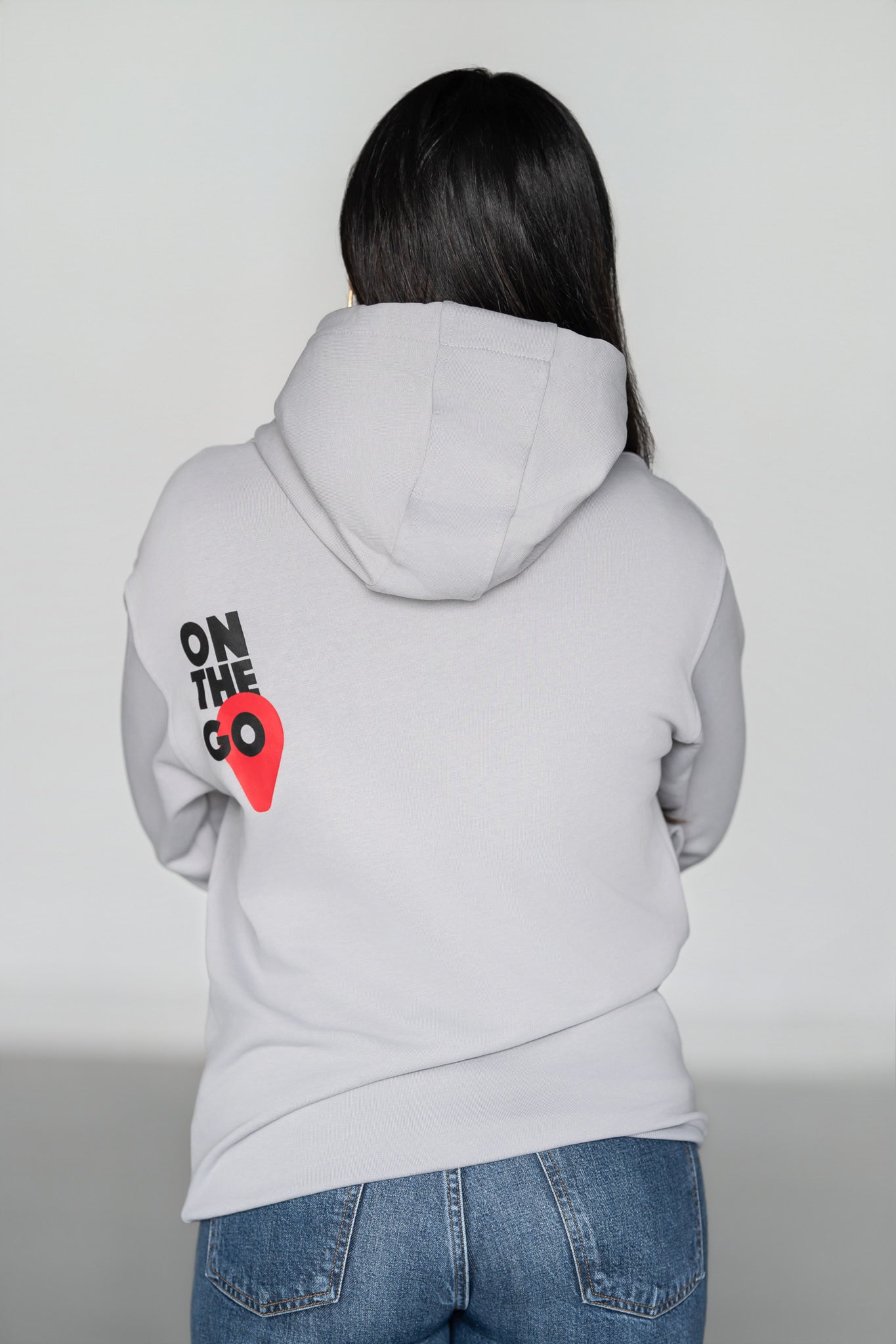 OOsmash On The Go Hoodie — women's back view, bold On The Go graphic, light gray French Terry Cotton, relaxed silhouette
