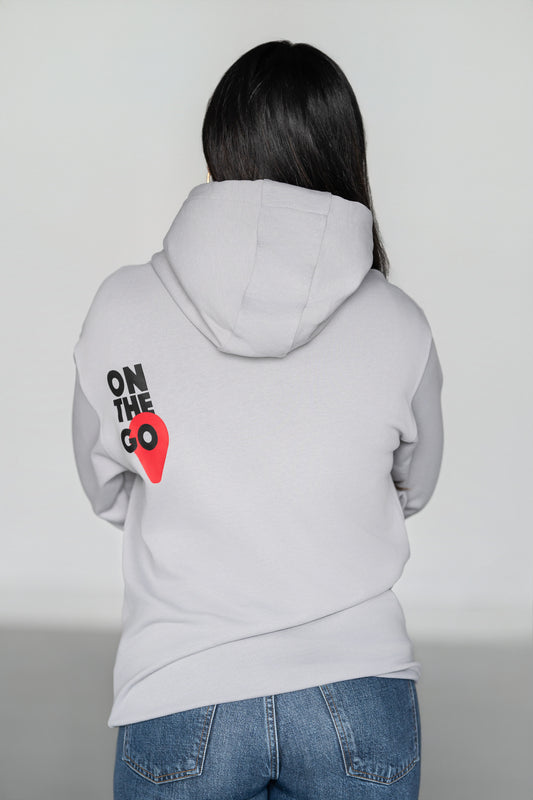 OOsmash On The Go Hoodie — women's back view, bold On The Go graphic, light gray French Terry Cotton, relaxed silhouette
