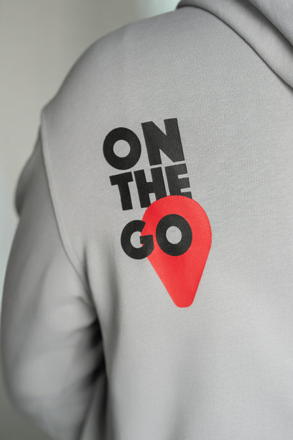 OOsmash On The Go Hoodie — women's close-up of On The Go graphic print, bold logo detail, light gray French Terry Cotton