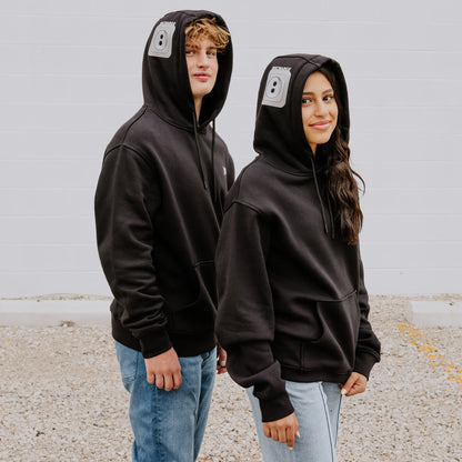 Two teens rocking black OOsmash Plug Hoodies with gray outlet design—recharge your energy, own your vibe 