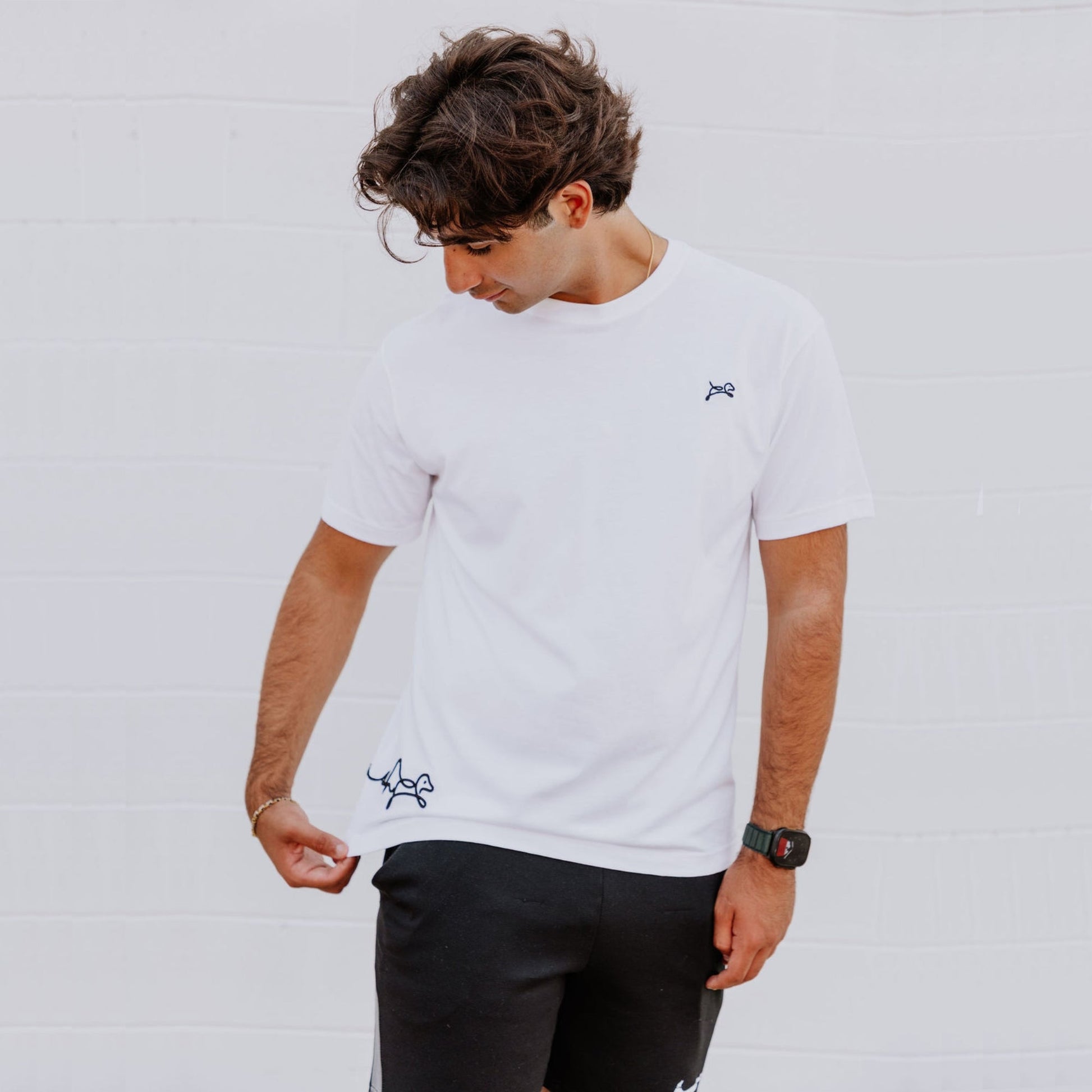 Model wearing OOsmash men’s white T-Shirt featuring clean stitching and relaxed fit.