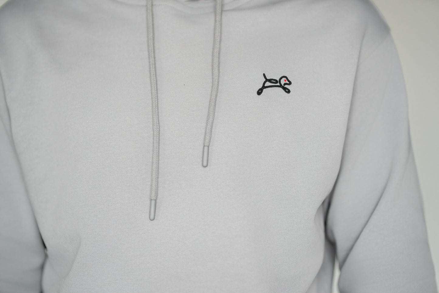 OOsmash On The Go Hoodie — close-up OOsmash embroidered logo on chest, stitch detail, premium French Terry hoodie