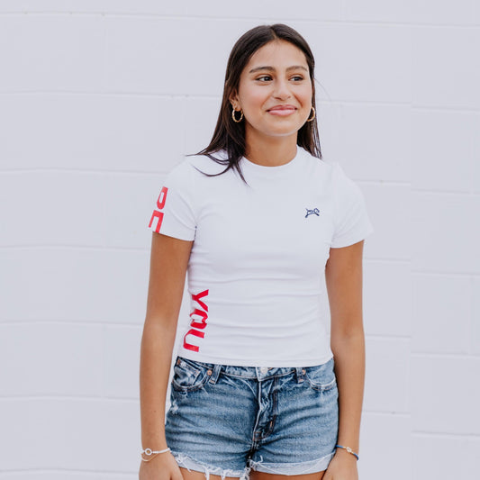 Model wearing OOsmash white crop tee featuring smooth fabric and flattering cropped cut.
