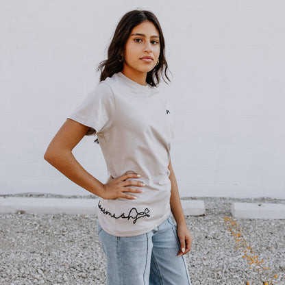 Model wearing OOsmash women’s beige T-Shirt featuring smooth fabric and flattering tailored fit.