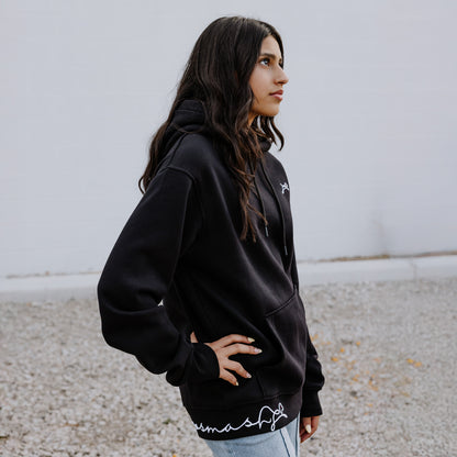 Female Model wearing OOsmash women’s Signature hoodie in black with soft, premium fabric.